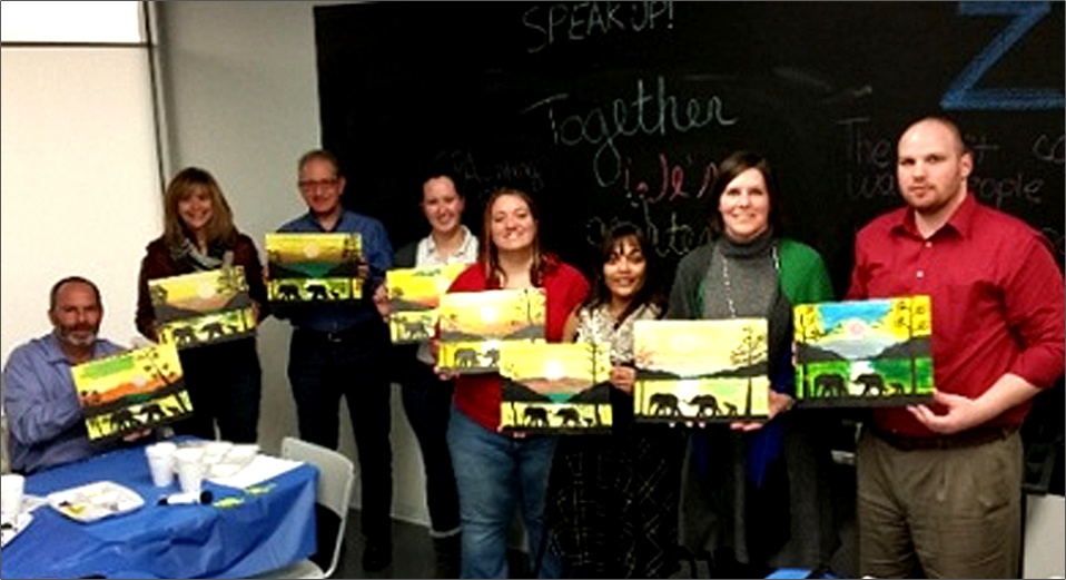 Image of Zinner team holding painted pictures for charity
